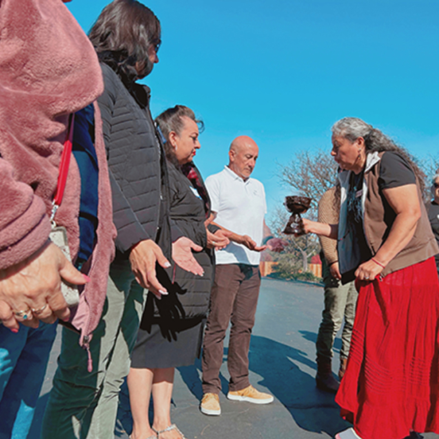 LuLu Pérez Centurion (Community Health Worker and Founder of Botanical Bus Planting Seeds of Self-Care program) welcoming clients to the Botanical Bus Mobile Herb Clinic.