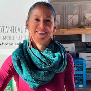 Ana Moreno (herbal apprentice) blending herbal tea at Botanical Bus Mobile Herb Clinic.