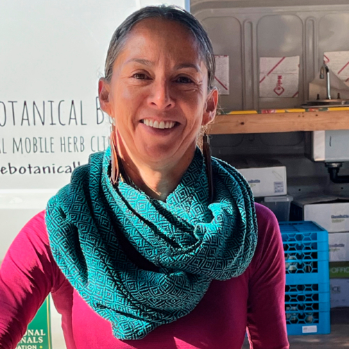 Ana Moreno (herbal apprentice) blending herbal tea at Botanical Bus Mobile Herb Clinic.