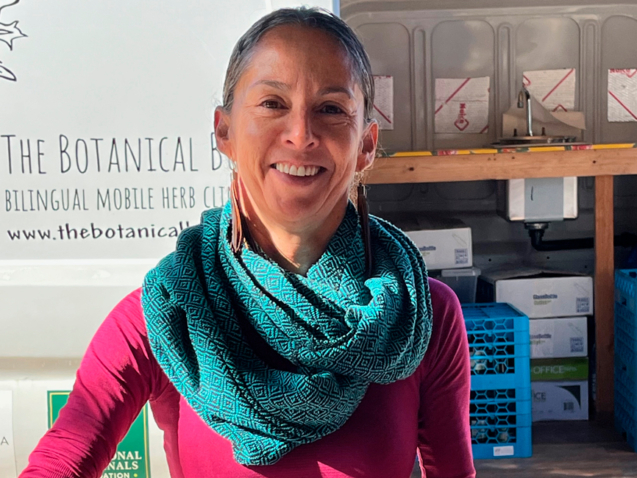 Ana Moreno (herbal apprentice) blending herbal tea at Botanical Bus Mobile Herb Clinic.